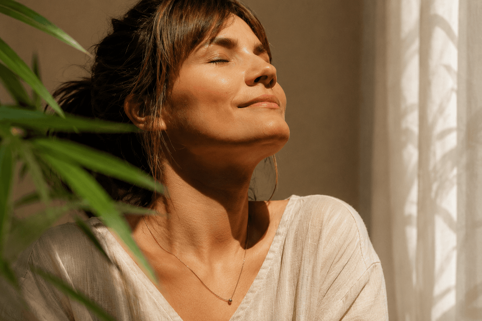 A woman experiencing everyday wellness, in a calm natural setting